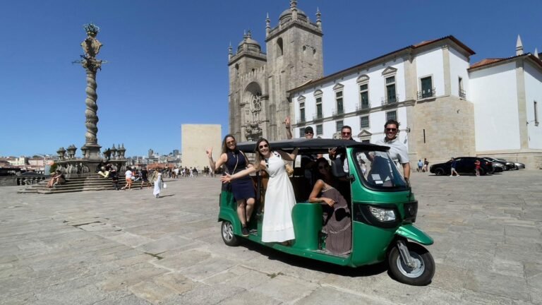 Guests with a green private tuk-tuk in front of Porto Cathedral