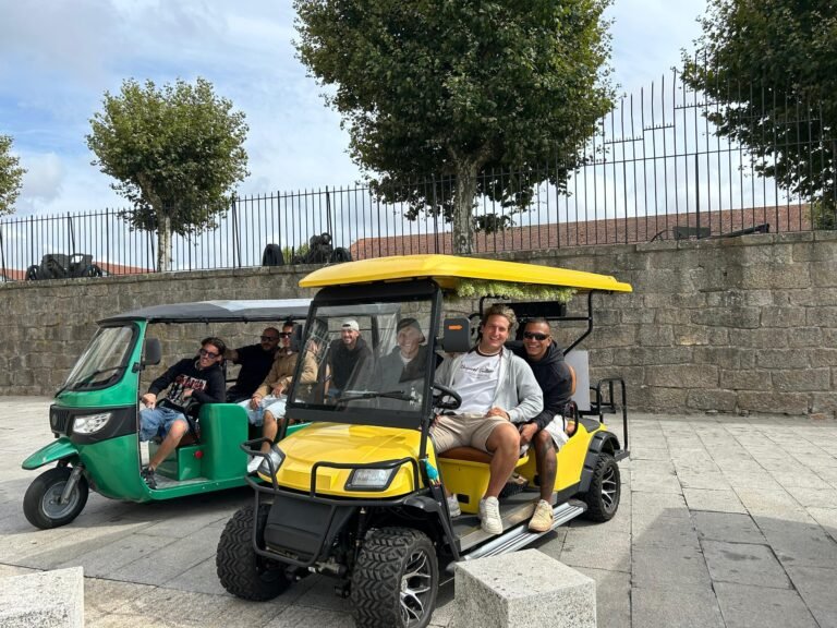 Guests enjoying private tours in yellow and green electric tuk-tuks in Porto
