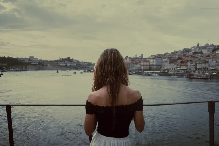 Traveller admiring Porto’s historic waterfront from the Douro riverside