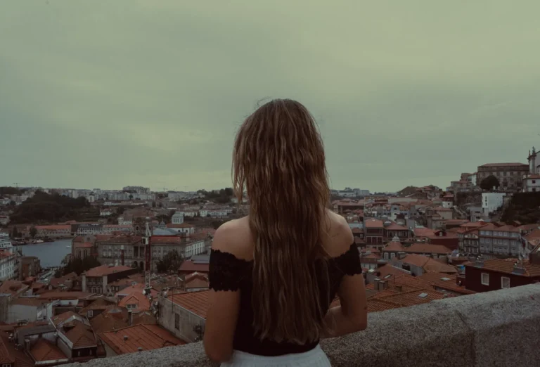 Traveller taking in the rooftops and historic centre of Porto from a scenic viewpoint